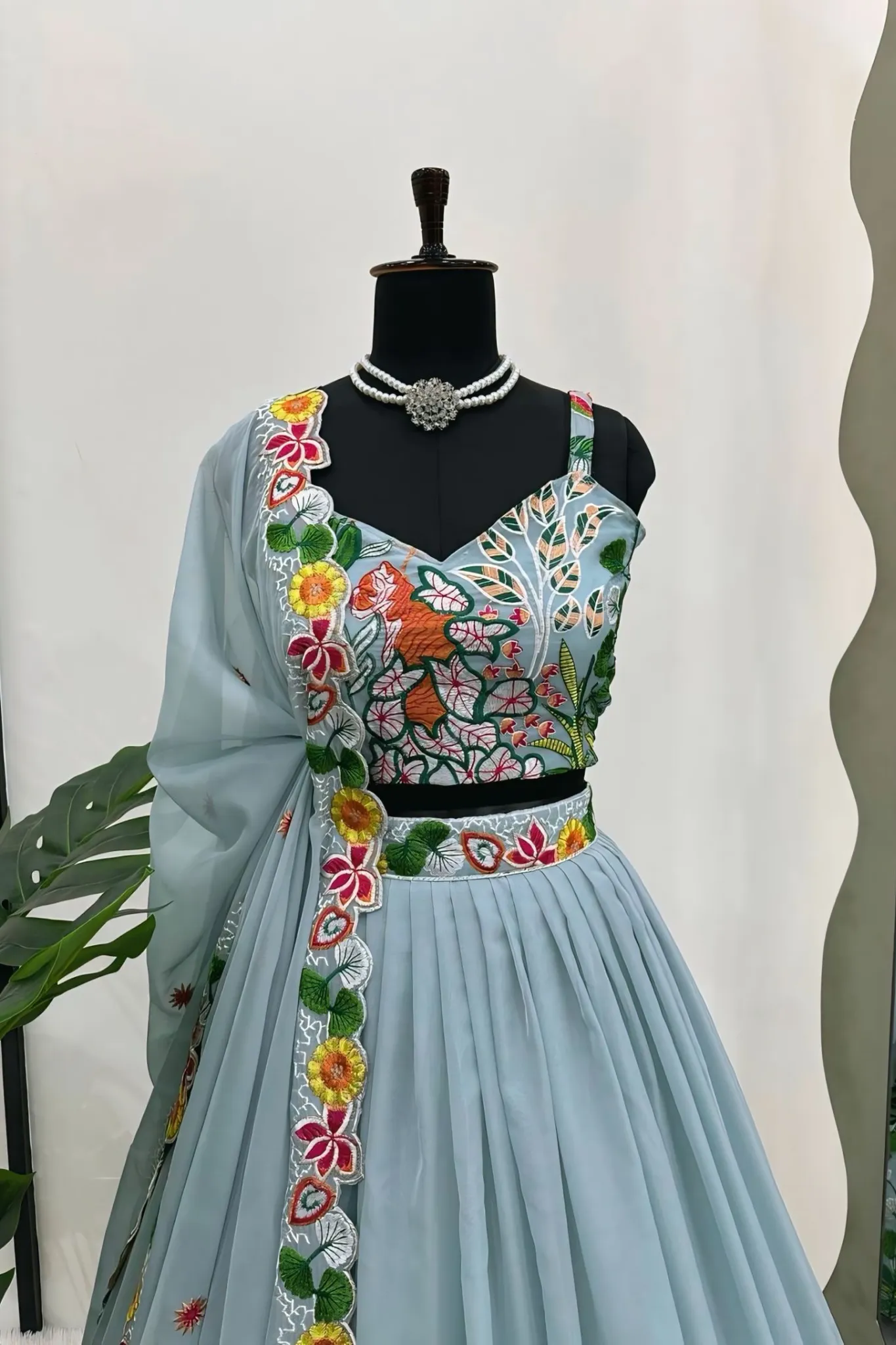 A FLOWERS LEHENGA CHOLI IS A TRADITIONAL INDIAN OUTFIT CHARACTERIZED ELEGANT DESING