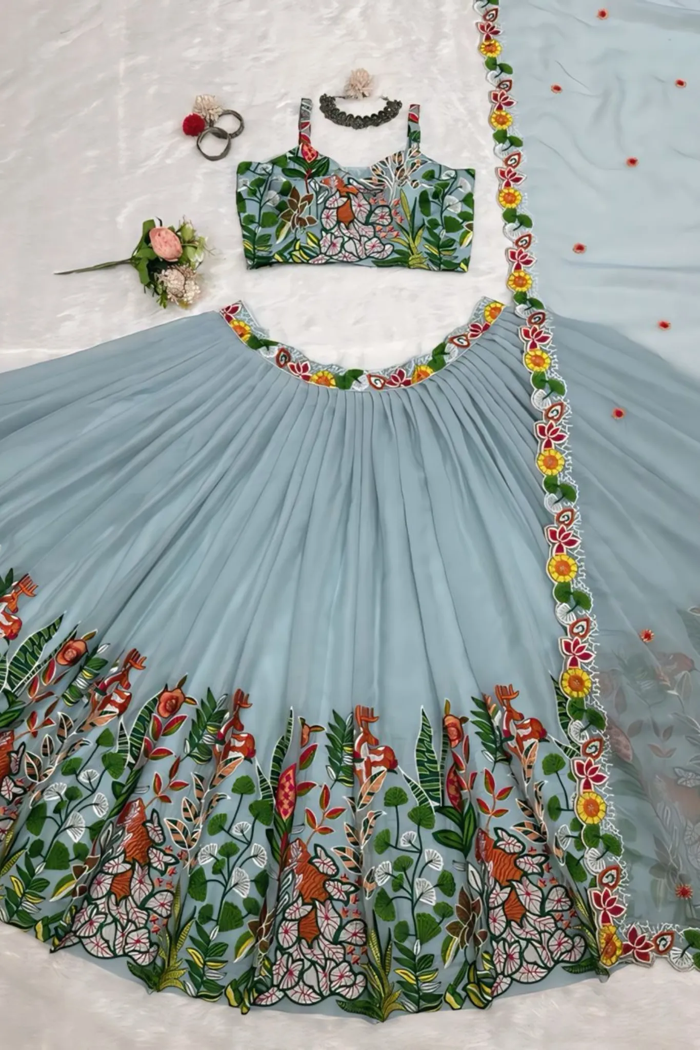 A FLOWERS LEHENGA CHOLI IS A TRADITIONAL INDIAN OUTFIT CHARACTERIZED ELEGANT DESING